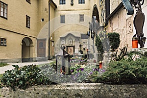 Cathedral church back yard with graves flower bed landscaping landmark Gothic view and handle lantern on ground