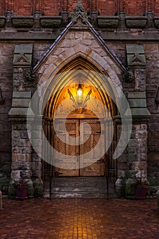 A cathedral door at dusk