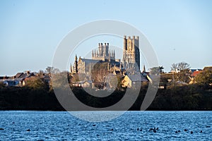 Cathedral of Ely with a lake infront during sunrise