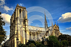 Cathedral of Notre-Dame in Paris feather clouds blue sky side view