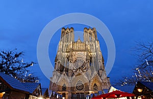 Cathedral of Notre Dame, Reims and Christmas market stalls in the night. One of the most stunning masterpieces of 13th