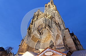 Cathedral of Notre Dame, Reims and Christmas market stalls in the night. One of the most stunning masterpieces of 13th