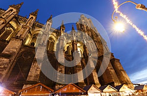 Cathedral of Notre Dame, Reims and Christmas market stalls in the night. One of the most stunning masterpieces of 13th