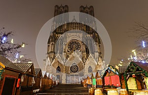 Cathedral of Notre Dame, Reims and Christmas market stalls in the night. One of the most stunning masterpieces of 13th