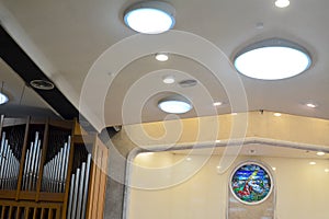 Cathedral with organ pipes and mosaic glass windows