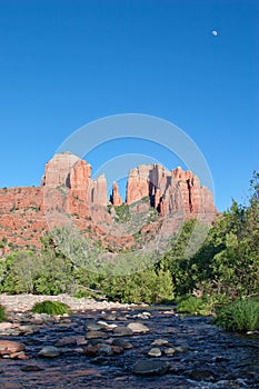Cathedral Rock and Oak Creek amidst green summer foliage near Sedona, Arizona.