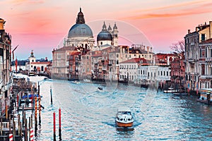 Cathedral Santa Maria della Salute tourists on gondola Grand Canal of Venice sunset, Italy