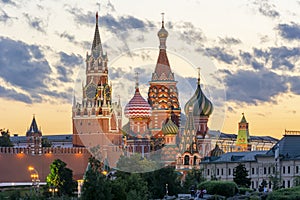 Cathedral of Vasily the Blessed Saint Basil`s Cathedral and Spasskaya Tower of Kremlin on Red Square at sunset, Moscow, Russia