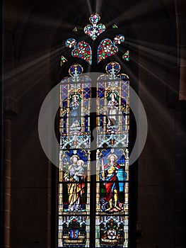 Cathedral window illuminated by sunlight