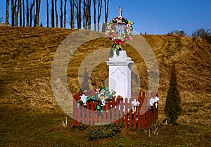 Catholic chapel with a group of trees, and the road leading up.