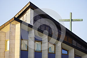 Catholic Church building in modern style, Catholic cross, modern architecture, stained glass, TV antenna on the roof