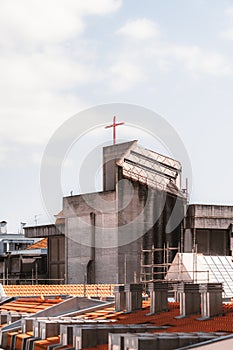 A Catholic church, city roofs