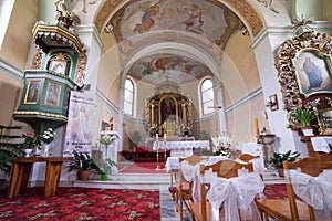 Catholic church interior with pews, statues and altar