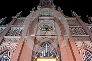 Catholic church towers up in the dark of night. The facade of Da Nang Cathedral