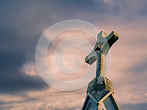 Catholic cross against blurred cloudy sky background, Copy space. Symbol of faith
