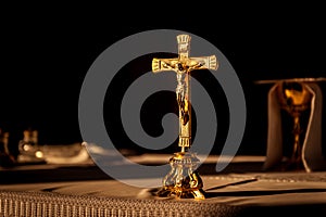 Catholic cross on altar in church lit by sunlight