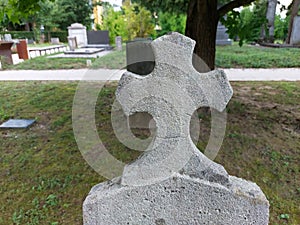 catholic cross at old cemetery in Ptuj. Light gray. Slovenia