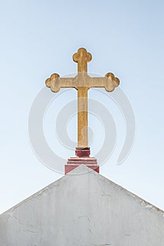 Catholic cross on the roof of a house photo