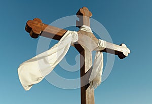 Catholic cross and white fabric photo