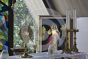 Catholic Eucharistic adoration chapel with Divine Mercy picture of Jesus Christ, candles and holy bread of life.