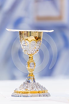 Catholic Holy Mass - covered golden chalice with wine on the altar