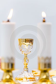 Catholic Holy Mass - golden chalice with wine on the altar