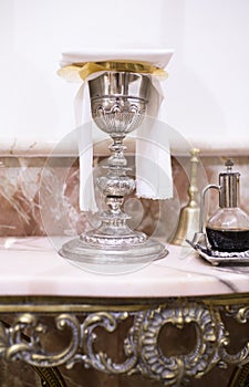 Catholic liturgical chalice, wine pitcher and bell