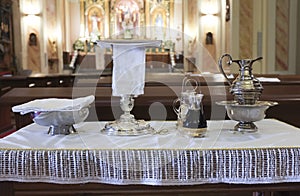 Catholic liturgical object. Chalice, communion wafers, wine, water, ewer and basin