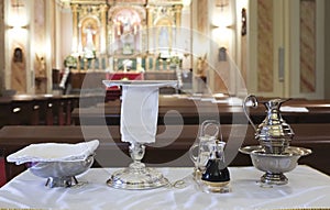 Catholic liturgical object. Chalice, communion wafers, wine, water, ewer and basin