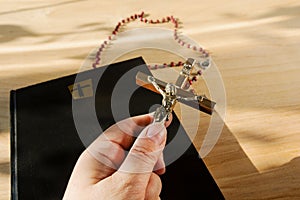 Catholic paraphernalia. Crucifixion of Jesus, Bible and Holy Rosary