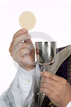 Catholic priest with chalice and host at Communion photo