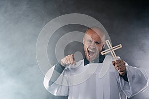Catholic priest exorcist in white surplice and black shirt