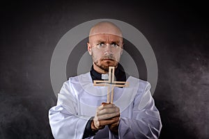 Catholic priest in white surplice and black shirt photo