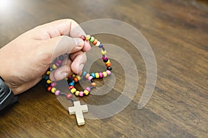 Catholic rosary beads in hand