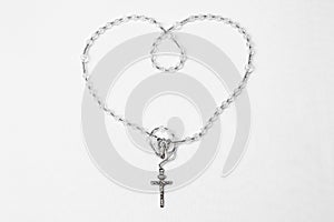 Catholic rosary with crucifix and medal of Virgin Mary on white background . Rosario catÃÂ³lico con crucifijo y medalla de la photo