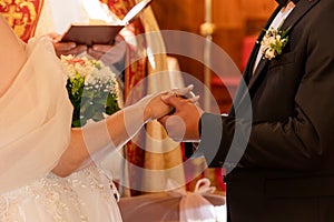 Catholic wedding church man puts ring woman after blessing Catholic wedding betrothal