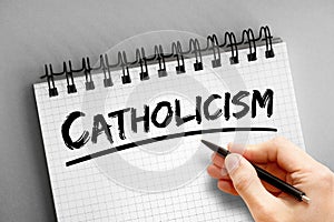 Catholicism text on notepad, concept background