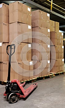 Catron boxes and pallet truck in warehouse