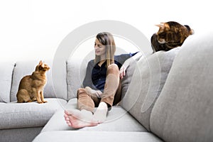 Cats and woman in the living room on the couch