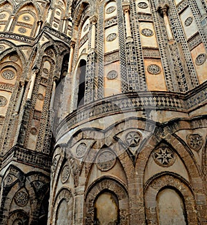 Master piece of art the Cathedral of  Monreale, facade detail arches, windows and coloured marbles