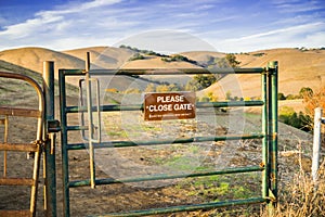 Cattle gate on one of the hiking trails in Garin Dry creek Pioneer Regional Park in east San Francisco bay, California photo