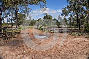 A cattle grid and a closed steel gate at the entrance to a farm