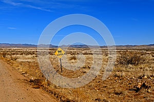 CATTLE sign in an open range area