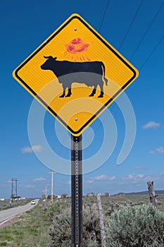 Cattle warning sign with UFO graffiti, New Mexico