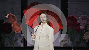 Catwalk charming woman open umbrella defile model show closeup evening vogue 4K.