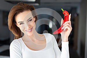 Caucasian 30s woman holding red chilli pepper