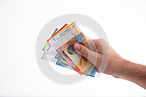 Caucasian adult male hand holding 4 Swiss currency francs cash bank notes isolated on white