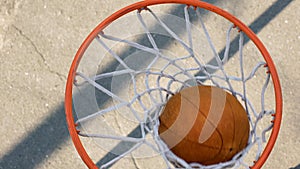 Caucasian athletic male shooting ball through basket, professional player