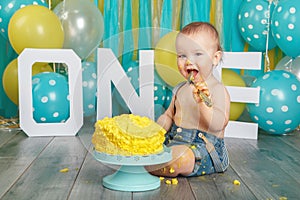 Caucasian baby boy celebrating his first birthday. Cake smash