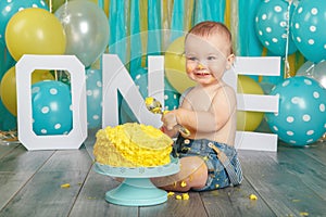 Caucasian baby boy celebrating his first birthday. Cake smash